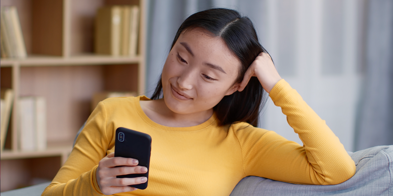 Image of a young woman looking at her cellphone